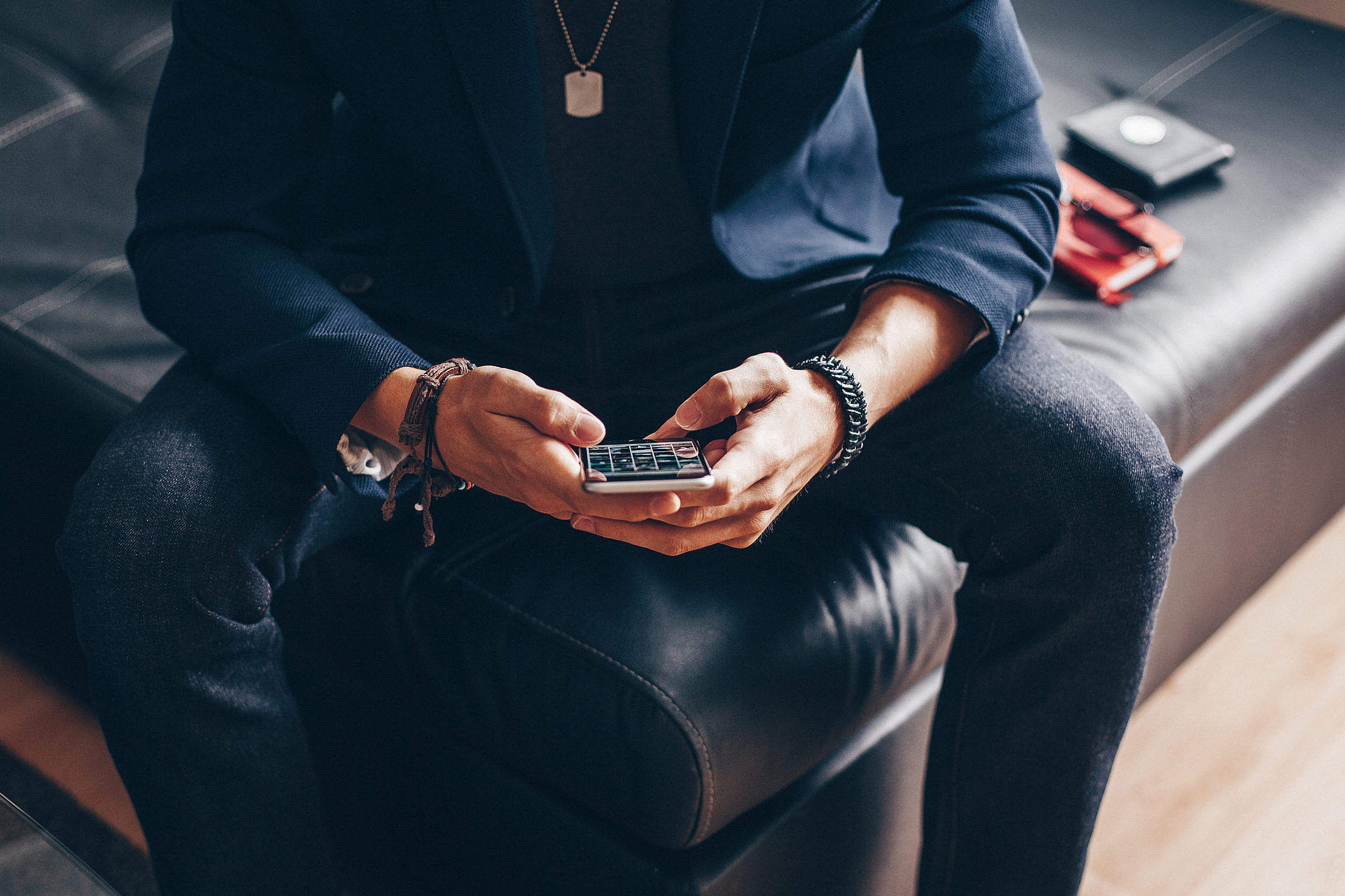 man-using-his-iphone-6-on-a-sofa-2210x1473